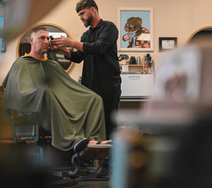 Barber cutting men's hair in Allen Texas Barbershop