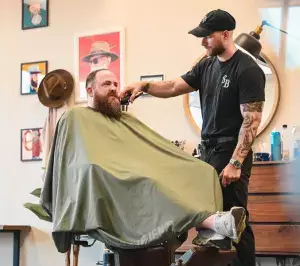 Barber doing beard trim in Allen Texas barbershop
