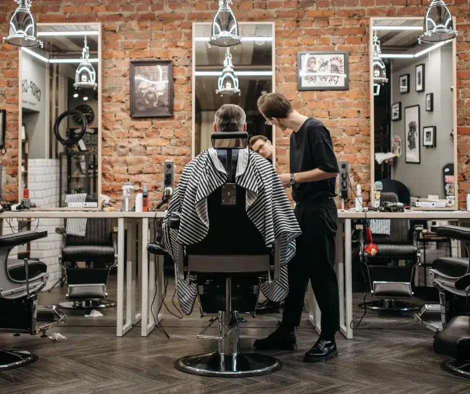 Barber cutting a clients hair in a barbershop